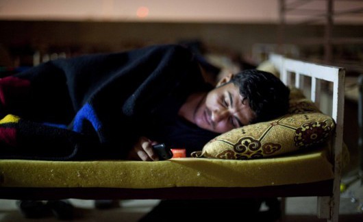 Sahir Jundi Hussein a young Arab worker plays with his mobile phone on the roof of the Asia Hotel in Sulaimaniyah Iraq
